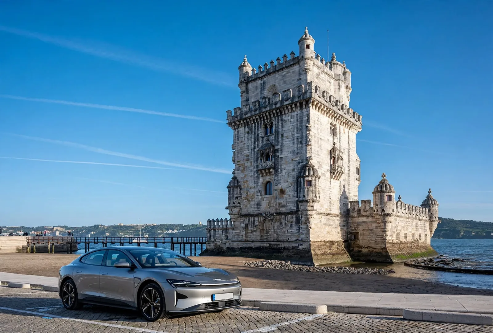 Silver executive sedan parked by the Belem Tower on the Lisbon waterfront